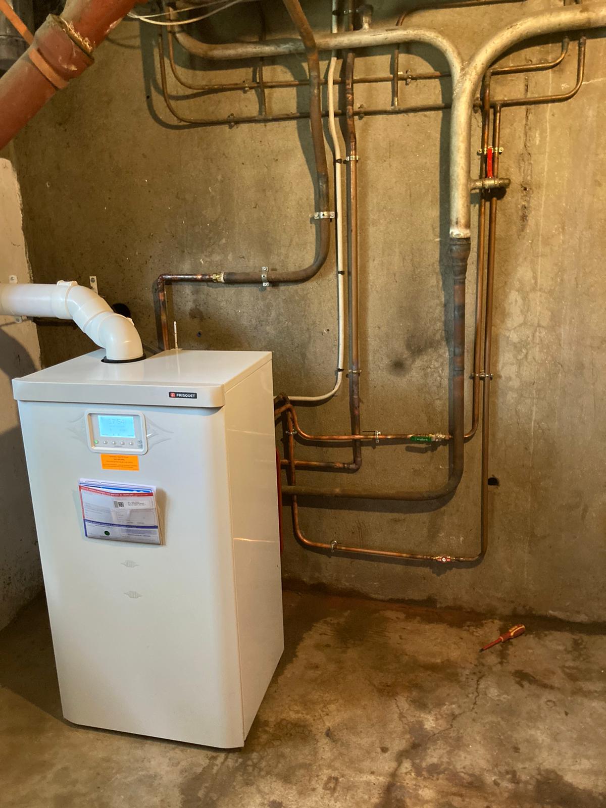 réalisation plombier chauffagiste Val‑d’Oise – Montage d'une chaudière à gaz au sol de marque Frisquet en Île‑de‑France.